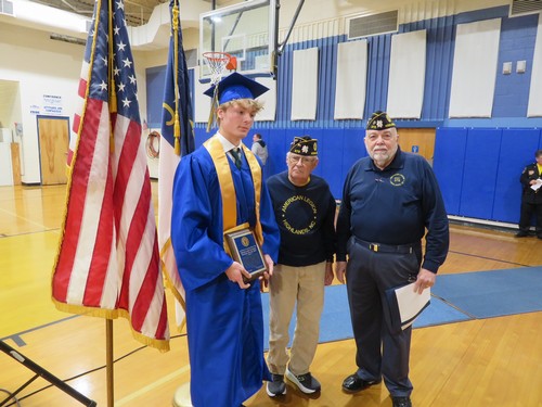 Adjutant, Ken Knight and Former Commander, Ed McCloskey present Finneaus with the plaque that accompanied the cash award.